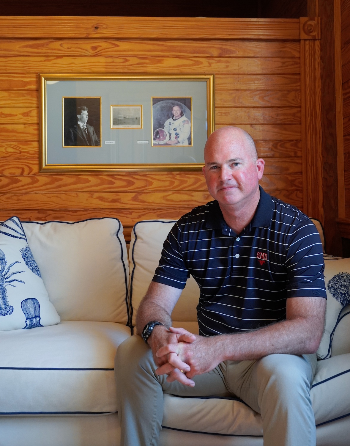 Clark Twiddy sits on a couch in the Corolla office — employee housing