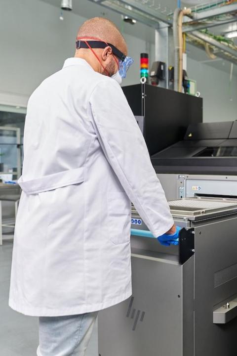 HP Metal Jet S100 Operator 3D printing metal parts in a lab