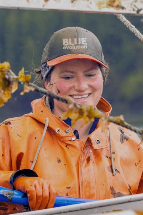 A Blue Evolution employee on a seaweed harvesting boat — seaweed farming