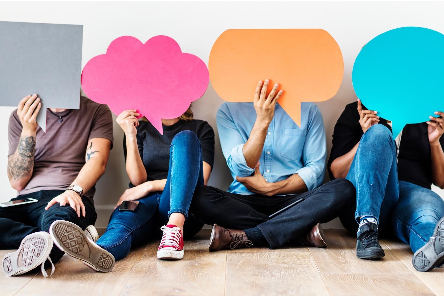 people holding paper thought bubbles - consumer sentiment