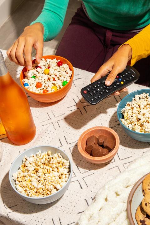 Two Friends Snacking and Watching Television