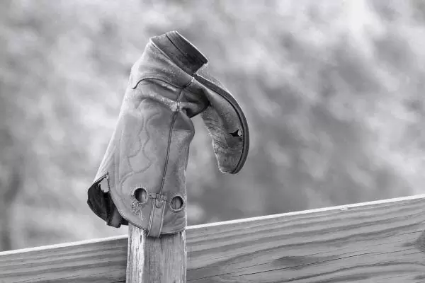 waterproof slip on work boot is hung on a fence for drying